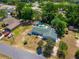Aerial view of a single-Gathering home featuring a pool, screened-in patio, and detached garage at 8198 Se 164Th Pl, Summerfield, FL 34491
