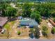 Aerial view of the property showing the home's green roof, pool, and large backyard area at 8198 Se 164Th Pl, Summerfield, FL 34491