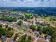 Wide aerial view showcasing the home's location near a golf course and residential area at 8198 Se 164Th Pl, Summerfield, FL 34491