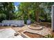 A serene backyard retreat with a custom-designed patio, cozy seating, and lush landscaping, perfect for relaxation and entertaining at 8198 Se 164Th Pl, Summerfield, FL 34491
