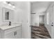 Modern bathroom features a single sink vanity with a mirror and a view into the bedroom at 8198 Se 164Th Pl, Summerfield, FL 34491