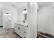 Updated bathroom features double sinks with modern hardware, and white cabinetry at 8198 Se 164Th Pl, Summerfield, FL 34491