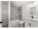 Stylish bathroom offers a shower-tub combination with a tiled wall, a vanity and a mirrored cabinet at 8198 Se 164Th Pl, Summerfield, FL 34491