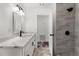 Bright bathroom featuring an expansive vanity with shower tiled in warm, neutral shades at 8198 Se 164Th Pl, Summerfield, FL 34491