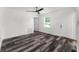 This bedroom features modern wood grain flooring and a contemporary ceiling fan at 8198 Se 164Th Pl, Summerfield, FL 34491