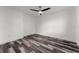 This empty bedroom features wood grain flooring and a contemporary ceiling fan at 8198 Se 164Th Pl, Summerfield, FL 34491
