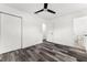 Well-lit bedroom with new flooring, a ceiling fan, closet, and ensuite bathroom at 8198 Se 164Th Pl, Summerfield, FL 34491