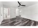 Open bedroom space features wood grain flooring and convenient access to the bathroom and kitchen at 8198 Se 164Th Pl, Summerfield, FL 34491