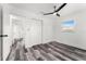 Cozy bedroom features modern flooring, fan, closet, and a window providing natural light at 8198 Se 164Th Pl, Summerfield, FL 34491