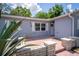 Welcoming front entrance featuring a charming patio and well-maintained landscaping adding curb appeal at 8198 Se 164Th Pl, Summerfield, FL 34491