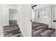 A hallway showcases modern flooring leading to a bright bedroom with natural light at 8198 Se 164Th Pl, Summerfield, FL 34491