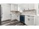 Updated kitchen features white cabinets, stone countertops, stainless steel appliances and backsplash at 8198 Se 164Th Pl, Summerfield, FL 34491