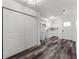 Bright kitchen features white cabinetry, marble counters, stainless faucet and modern wood grain floors at 8198 Se 164Th Pl, Summerfield, FL 34491