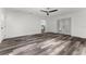 Living room with hard flooring, open layout, ceiling fan, and sliding doors leading to the backyard at 8198 Se 164Th Pl, Summerfield, FL 34491