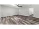 Bright and airy living room with stylish, hard flooring, a ceiling fan, and plenty of natural light at 8198 Se 164Th Pl, Summerfield, FL 34491