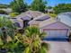 Aerial view of a well-maintained home boasting lush landscaping and a paved driveway in a serene neighborhood at 910 Eagles Lndg, Leesburg, FL 34748
