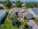 Aerial view of landscaped house with a brick driveway and mature trees, located in a peaceful neighborhood at 910 Eagles Lndg, Leesburg, FL 34748