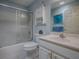 Bathroom featuring white vanity, shower-tub, and frosted glass doors at 910 Eagles Lndg, Leesburg, FL 34748