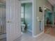 Bathroom view showing the toilet, shower and doorway to the adjacent bedroom with mirrored closet at 910 Eagles Lndg, Leesburg, FL 34748