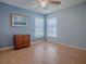 Bedroom featuring a ceiling fan, a bureau, and bright natural light from two windows at 910 Eagles Lndg, Leesburg, FL 34748