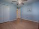 Bedroom with blue walls, ceiling fan, closet, and lots of natural light at 910 Eagles Lndg, Leesburg, FL 34748