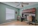 Bright bedroom featuring a built-in desk, ceiling fan and lots of natural light at 910 Eagles Lndg, Leesburg, FL 34748
