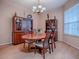 Dining room with hardwood table and chairs under a decorative chandelier near large display cabinets at 910 Eagles Lndg, Leesburg, FL 34748