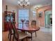 Bright dining room featuring an oval table with seating for four beneath an elegant chandelier at 910 Eagles Lndg, Leesburg, FL 34748