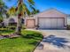 Charming single-story home with lush landscaping, a brick paver driveway, and a welcoming facade at 910 Eagles Lndg, Leesburg, FL 34748