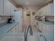 Open concept kitchen featuring white cabinets and countertops, flowing into a bright and airy design at 910 Eagles Lndg, Leesburg, FL 34748