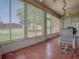 Enclosed lanai with tile flooring, ceiling fans, and views of the backyard at 910 Eagles Lndg, Leesburg, FL 34748