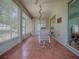 Spacious enclosed lanai with tile flooring, ceiling fans, and sliding glass doors to the interior at 910 Eagles Lndg, Leesburg, FL 34748
