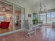 Enclosed lanai with tile flooring, ceiling fans, and sliding glass doors to indoor living area at 910 Eagles Lndg, Leesburg, FL 34748