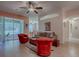 Open-concept living room with sliding glass doors to the lanai, comfortable seating, and wood flooring at 910 Eagles Lndg, Leesburg, FL 34748