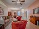 Open-concept living room featuring a ceiling fan, comfortable seating, and access to the dining area at 910 Eagles Lndg, Leesburg, FL 34748