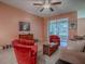 Cozy living room featuring comfortable red armchairs and glass sliding doors to an enclosed patio at 910 Eagles Lndg, Leesburg, FL 34748