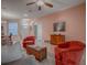 Spacious living room features wood flooring, ceiling fan, and cozy seating, ideal for relaxing and entertaining at 910 Eagles Lndg, Leesburg, FL 34748