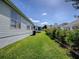 The exterior of the home with a view of the vinyl siding and green backyard at 1010 Ventura Dr, The Villages, FL 32159