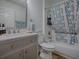 Bathroom with a modern vanity, patterned shower curtain, and standard toilet at 1010 Ventura Dr, The Villages, FL 32159