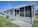 Exterior view of screened in porch and attached home at 1010 Ventura Dr, The Villages, FL 32159