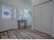 Well-lit foyer with wood floors, closet and front door, offering ample storage and a welcoming entrance at 1010 Ventura Dr, The Villages, FL 32159