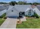 Attractive single-story home with a two-car garage, neat landscaping, and a cozy front porch area at 1010 Ventura Dr, The Villages, FL 32159