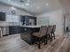 Modern kitchen features gray cabinets, stainless steel appliances, and an island with bar seating at 1010 Ventura Dr, The Villages, FL 32159
