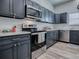 This modern kitchen features gray cabinets, stainless steel appliances, and light countertops at 1010 Ventura Dr, The Villages, FL 32159