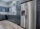 Modern kitchen features gray cabinets, stainless steel appliances, and light countertops at 1010 Ventura Dr, The Villages, FL 32159