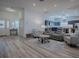 Bright and open living space with wood floors, connecting to kitchen and dining, ideal for modern living at 1010 Ventura Dr, The Villages, FL 32159