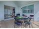 Outdoor patio with sliding glass door, vinyl siding, and table with four chairs at 1010 Ventura Dr, The Villages, FL 32159