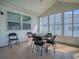 Enclosed sunroom with vinyl flooring, multiple windows, and a ceiling fan at 1010 Ventura Dr, The Villages, FL 32159