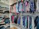 A well-organized walk-in closet filled with clothing racks and shelving, offering ample storage space at 1010 Ventura Dr, The Villages, FL 32159