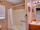 Bathroom with a shower-tub combination with tile surround and single sink vanity at 10166 Cr 671, Bushnell, FL 33513